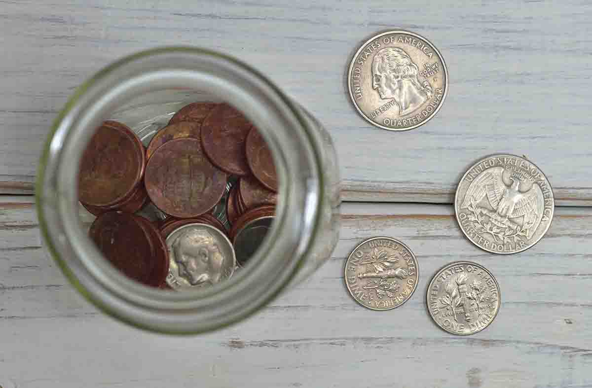A close-up of rare U.S. coins laid out on a wooden table