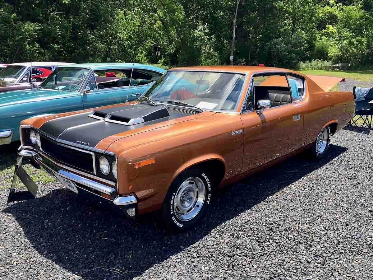 Orange 1970 AMC Rebel Machine parked on a classic car lot